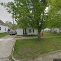 Man pounding on door of possibly empty home