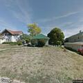 Man with metal detector entering backyards