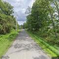 Tree on power lines blocking part of roadway