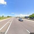 Pedestrian walking barefoot on I-88 ramp in Aurora
