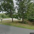 Person walking around property taking photos