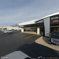 Person experiencing severe headache at car dealership