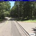 Person yelling on park trail near covered bridge