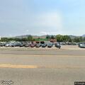 Officer contacts white Dodge at auto sales lot