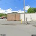Disabled tractor trailer leaking fuel in parking lot
