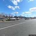 Man yelling in parking lot in white sport utility vehicle