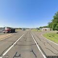 Person semi-responsive and dazed near blue vehicle on highway