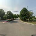 Traffic stop on blue sedan at apartment complex