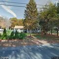 Hazardous tree branch over sidewalk and street