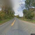 Person lying on side of road near Kelsey Road