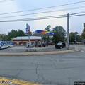 Disabled car with flat tire at country store lot