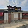 Officer checks vehicle stopped by restaurant