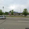 Woman shouting and blocking pumps at gas station