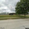Person unresponsive in red minivan at elementary school