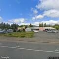 Trash burning under bus stop on South Redwood Highway
