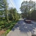 Motorcyclist jumps off bike into grass in Grafton