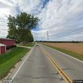 Semi truck driving with open rear door on Charles Rd