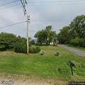 Disabled vehicle with person underneath on roadside