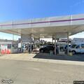 Officers monitor car meetup behind gas station