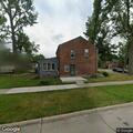 Suspicious black sedan parked outside home