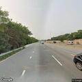 Person riding bicycle on highway breakdown lane