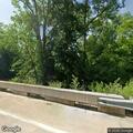 Officer escorts driver moving car off railroad bridge