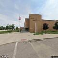 Person sitting by curb near South Lake High School