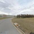 Man in 20s experiencing facial muscle cramps at distribution center