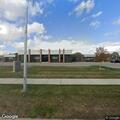 Person lying in grass near E 11 Mile Rd, Warren