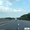 Erratic white SUV driving without lights on highway