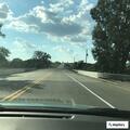 Officer checks on broken down car off roadway