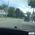 Person nodding off inside blue Hyundai at gas station