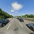 Officer assisting driver with flat tire on highway