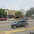 Car hits curbs and light pole on West Grand River