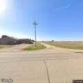 Suspicious driver in white car at rural property