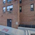 Men trying to enter apartment window in hallway
