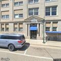 Person pulling on doors on North Pine Street