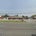 Man covered in blankets walking along road in Altamont