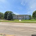 Woman semi-conscious and rolling on grass at apartment
