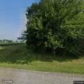 Suspicious person sitting on rural property