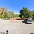 Suspicious woman leaves backpack by park dumpster