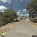 Suspicious person sitting in woods by apartments