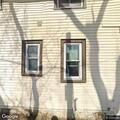 Garbage truck hits pole that falls onto house
