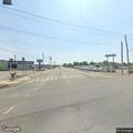 Person standing in road with shopping cart on boulevard
