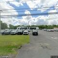 Car stopped on shoulder near GMC dealership