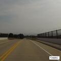 Van hauling wide wood load swerving on Highway 26