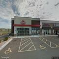 Officer checks unoccupied vehicle near restaurant