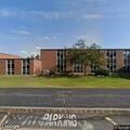 Woman with breathing difficulty at high school
