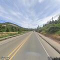 Woman confused and stumbling near intersection in Myrtle Creek