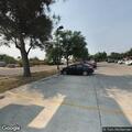 Female subject sitting in parking lot after running into traffic